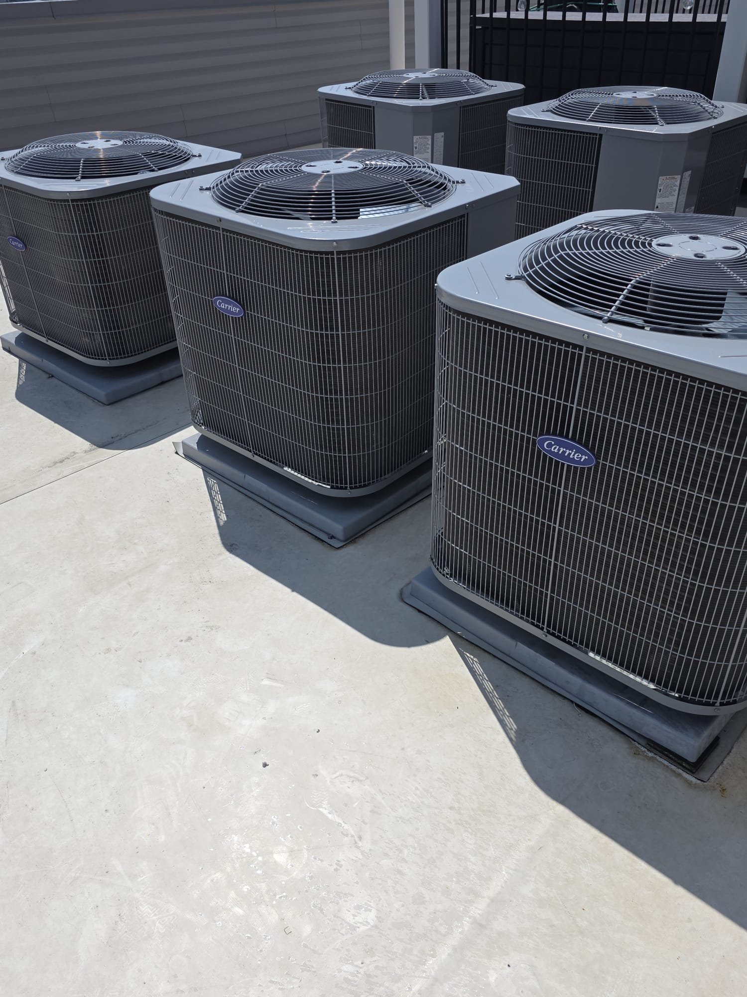 Row of Carrier rooftop AC units serviced