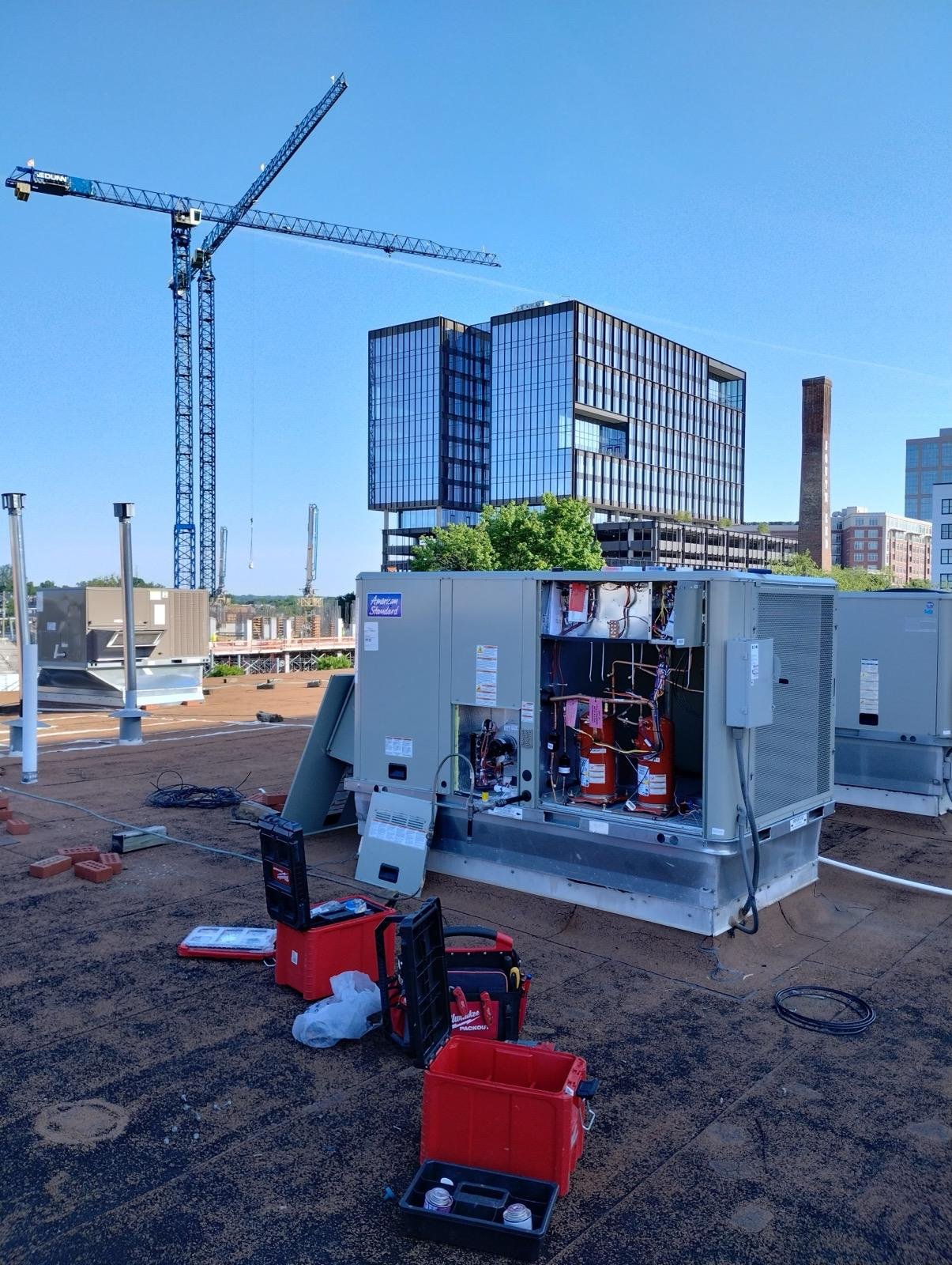 Commercial rooftop unit opened and serviced on site