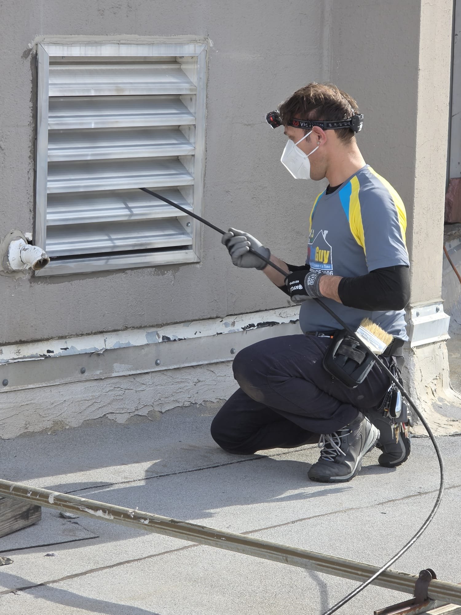 Technician cleaning a commercial dryer vent