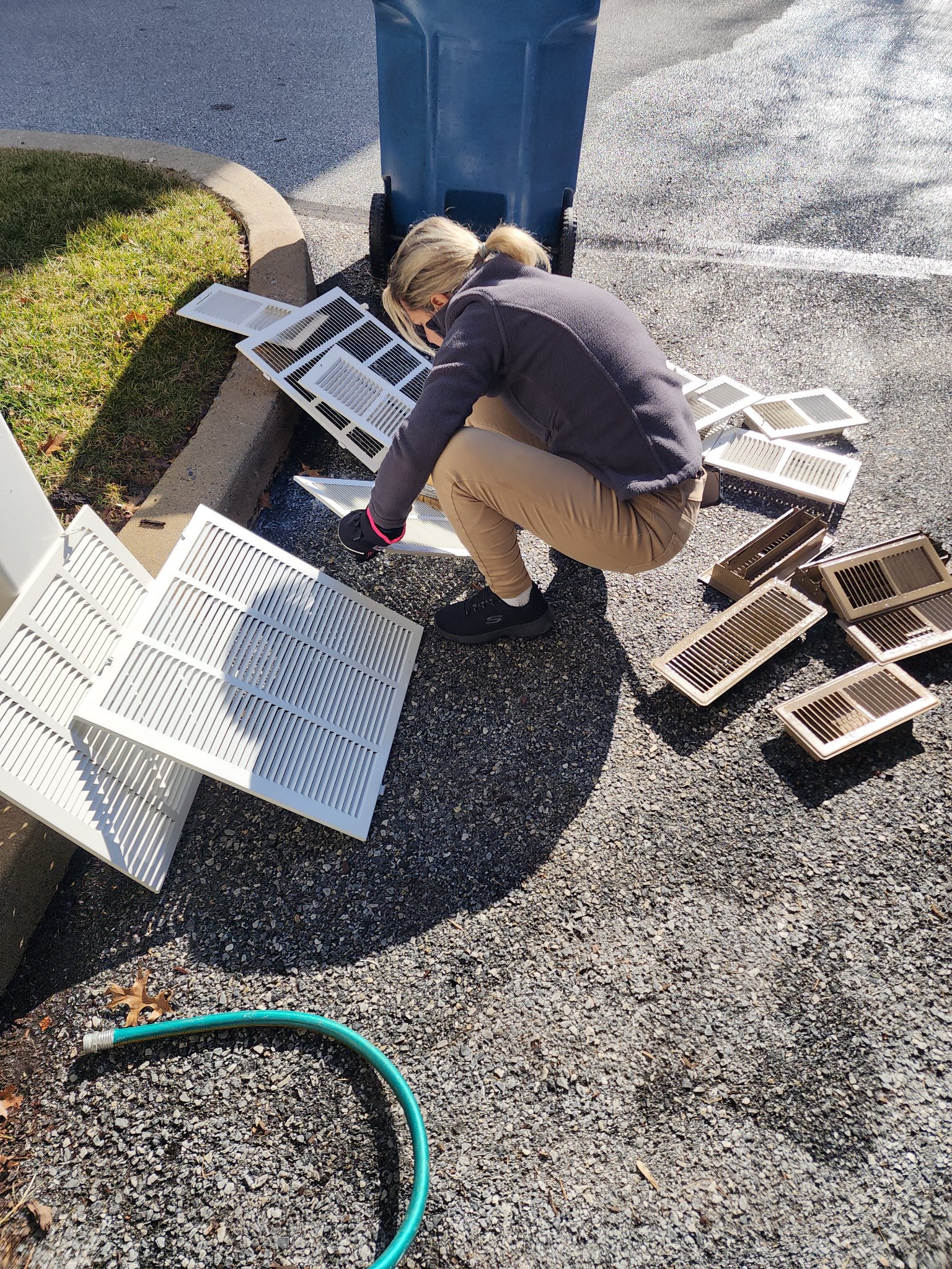 Vent covers being washed outside during a duct cleaning