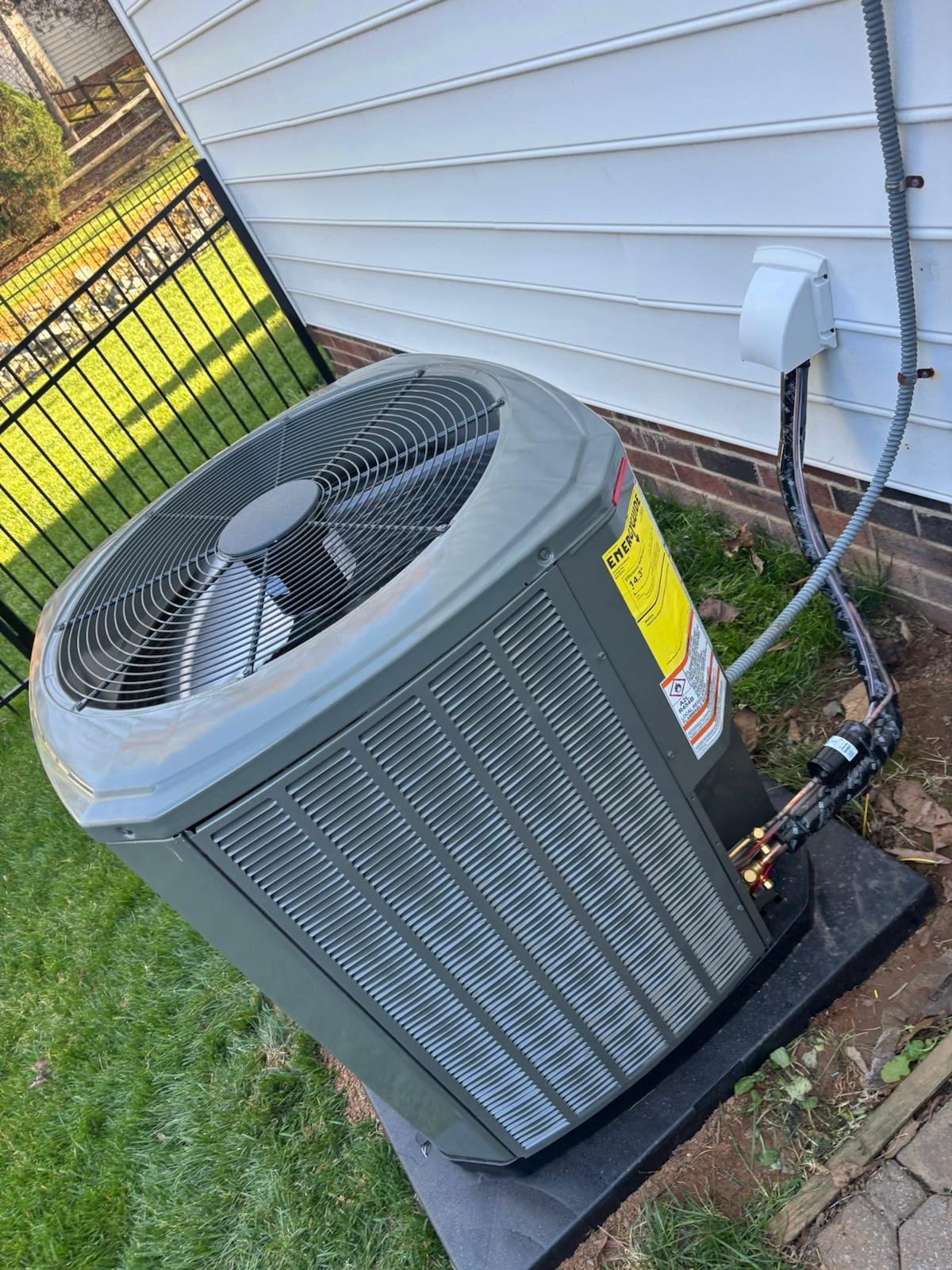 New AC condenser on a fresh pad