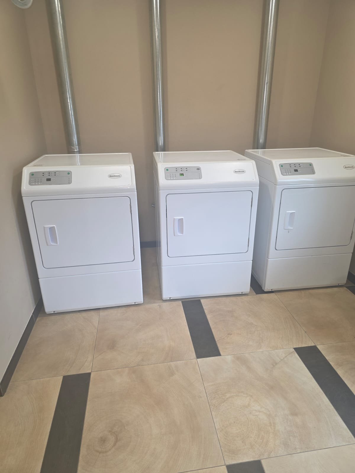 Row Of Commercial Dryers In A Laundromat