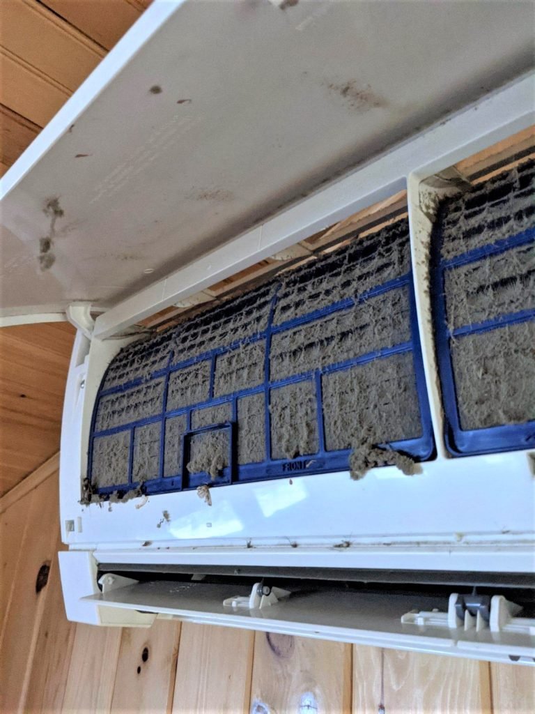 Mini-split filter caked with thick dust before deep cleaning