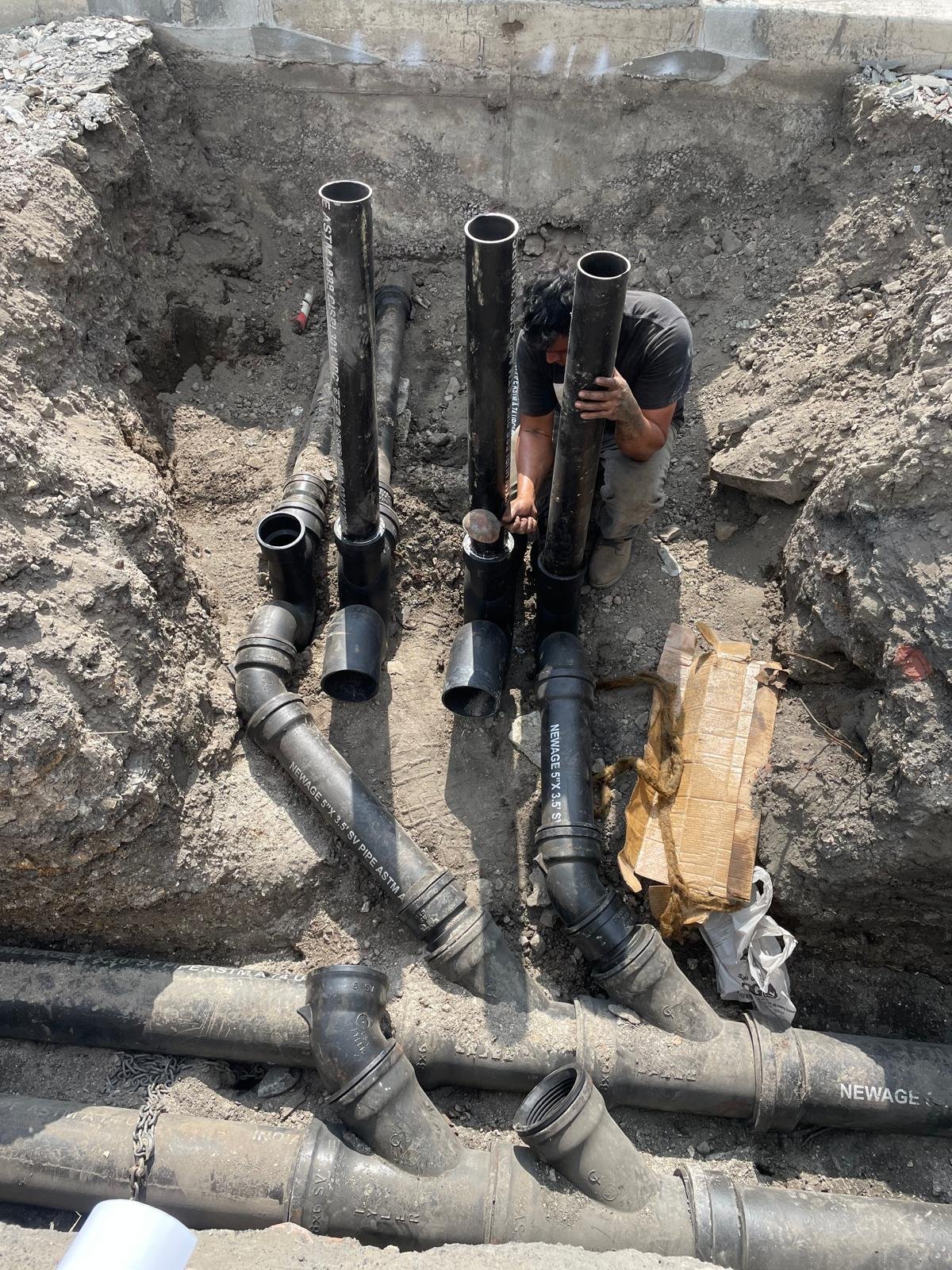 Underground sewer pipes being installed