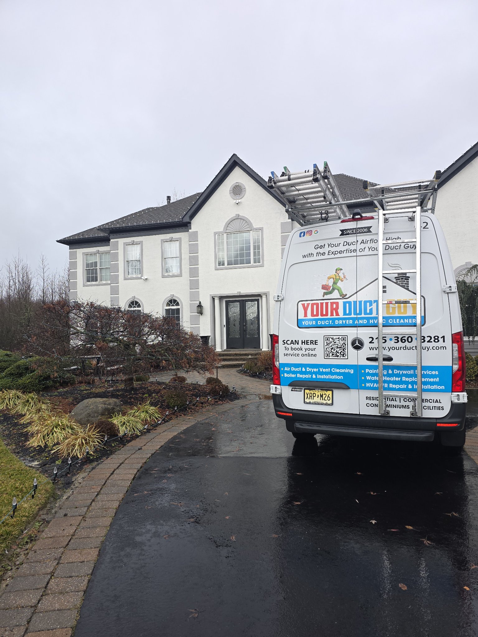 Your Duct Guy branded van parked at a beautiful home